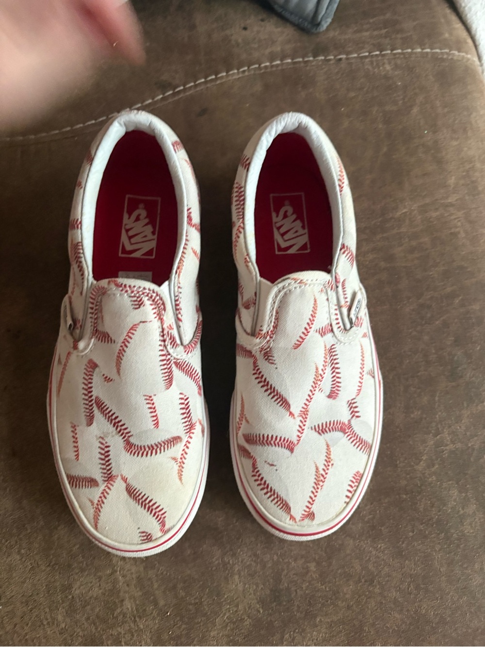 Vans Kids Slip-On Sneakers in White with Red Baseball Stitch Print